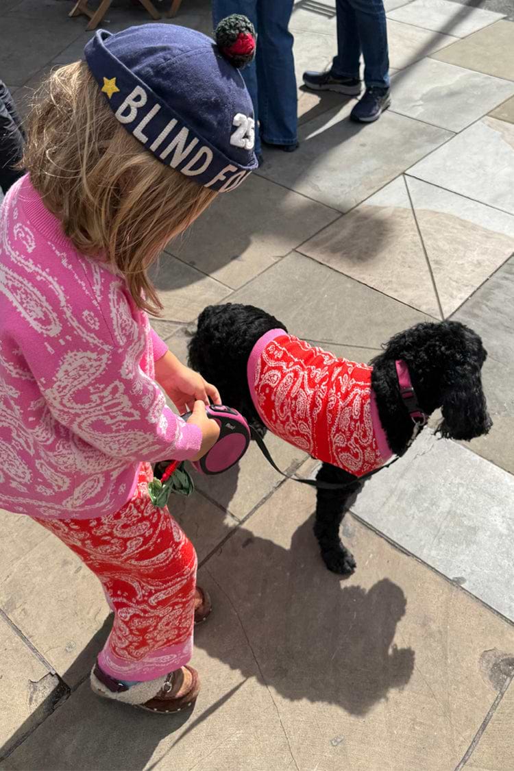 Red and Pink Bandana Dog Jumper on a black dog, styled with a matching kids' bandana knit set.
