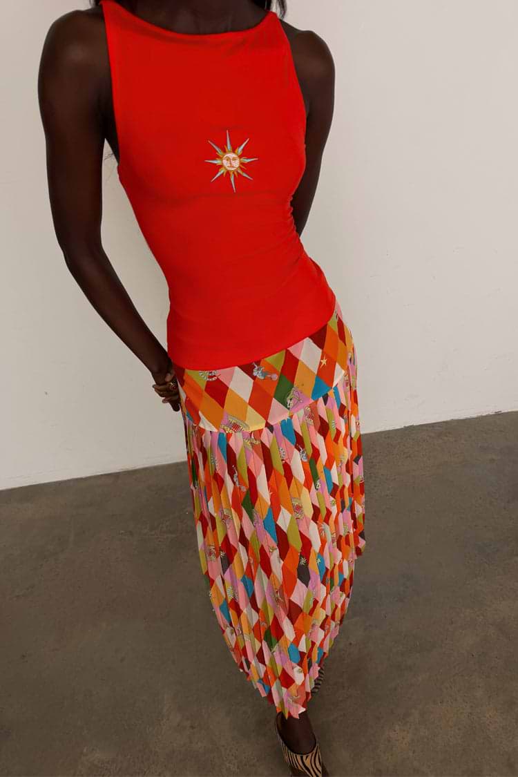 Cirque Beatrice Skirt featuring a multi-coloured geometric diamond print, cirque motifs and a pleated A-line hem.