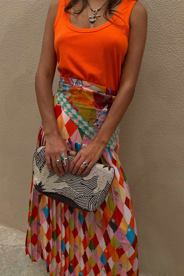 Cirque Beatrice Skirt in a colourful geometric print with cirque motifs and a pleated A-line silhouette.