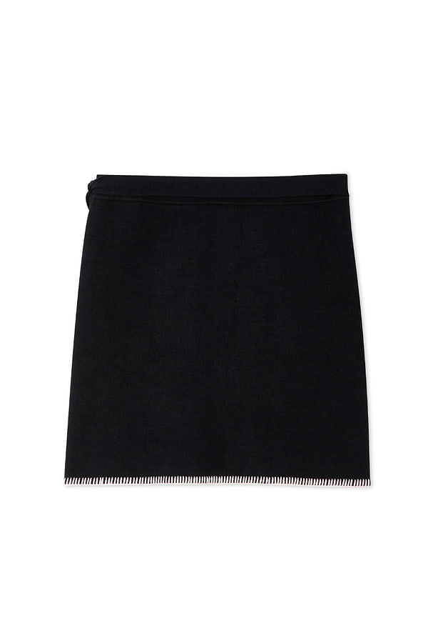 Black Night Garden Mini Wrap Skirt with a pink blanket stitch hem and side wrap tie in a soft-touch knit.