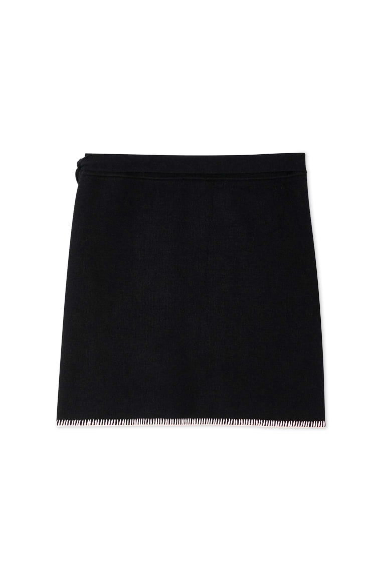 Black Night Garden Mini Wrap Skirt with a pink blanket stitch hem and side wrap tie in a soft-touch knit.