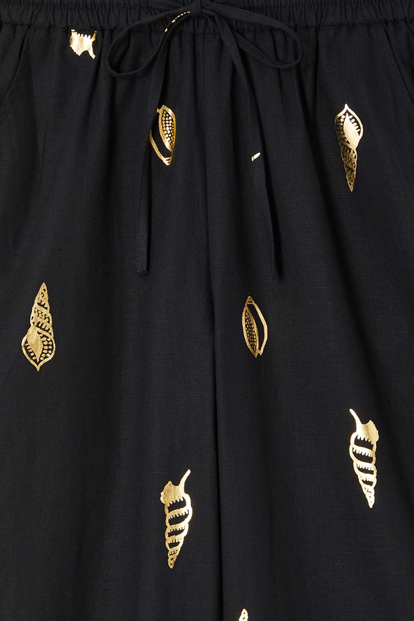 Black Shell Elissa Trousers detail showing the elasticated drawstring waist and metallic gold shell print.