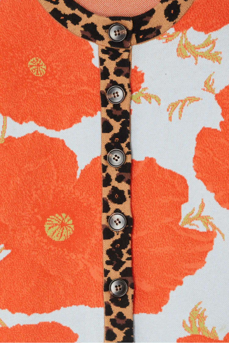 Blue Poppy Cardigan detail with bold orange poppies on pale blue knit and iconic leopard print collar and button stand.