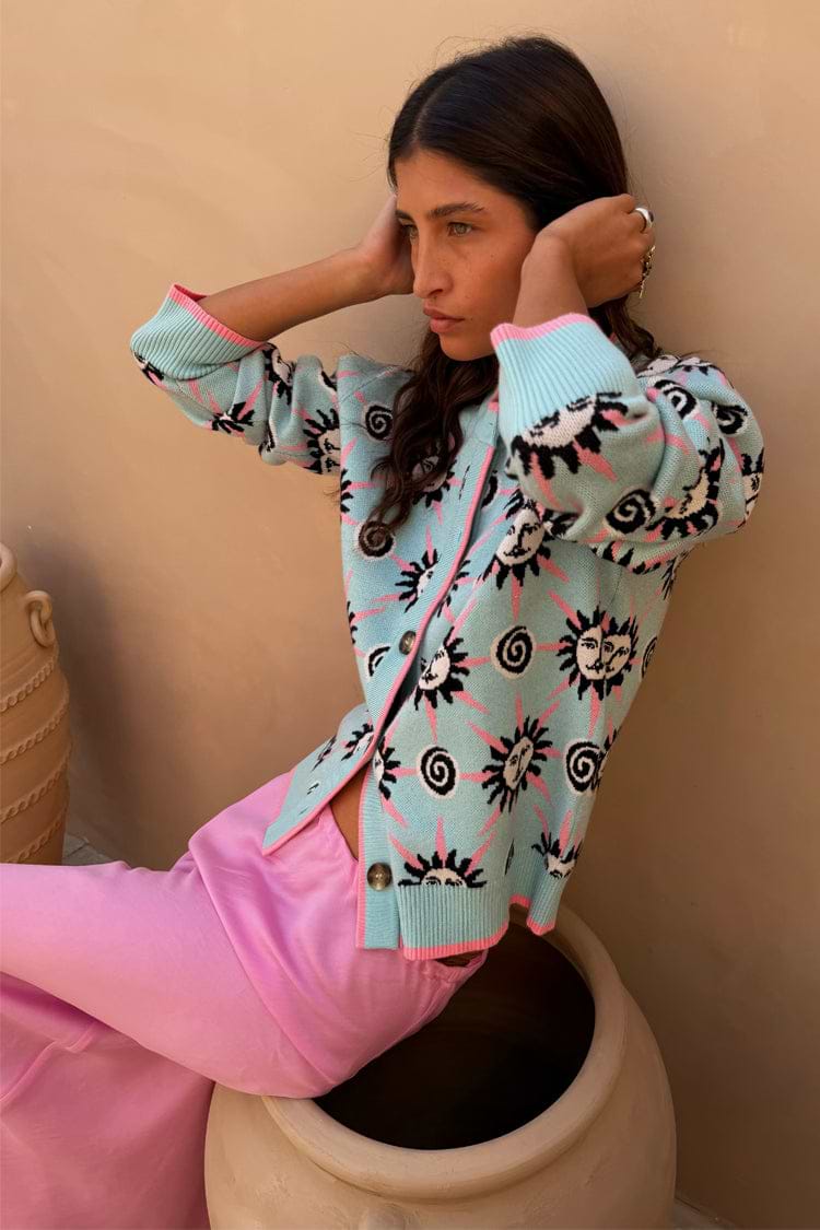 Blue Sun Hollie Cardigan in blue soft touch knit featuring pink sun prints and button-up fastening.