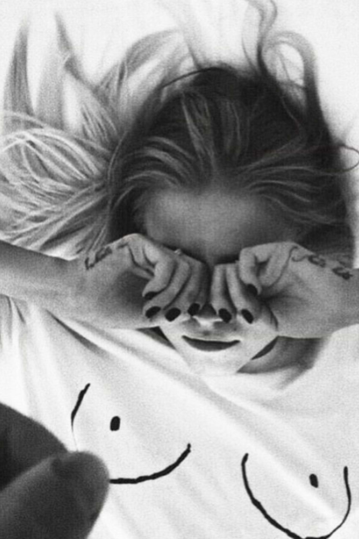 Iconic white Boob T-shirt with line drawing detail on a model lying down in black and white.
