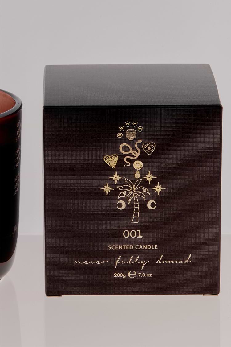 NFD Eau De Parfum Candle 001 packaging in dark brown featuring gold foil palm tree and celestial illustrations.