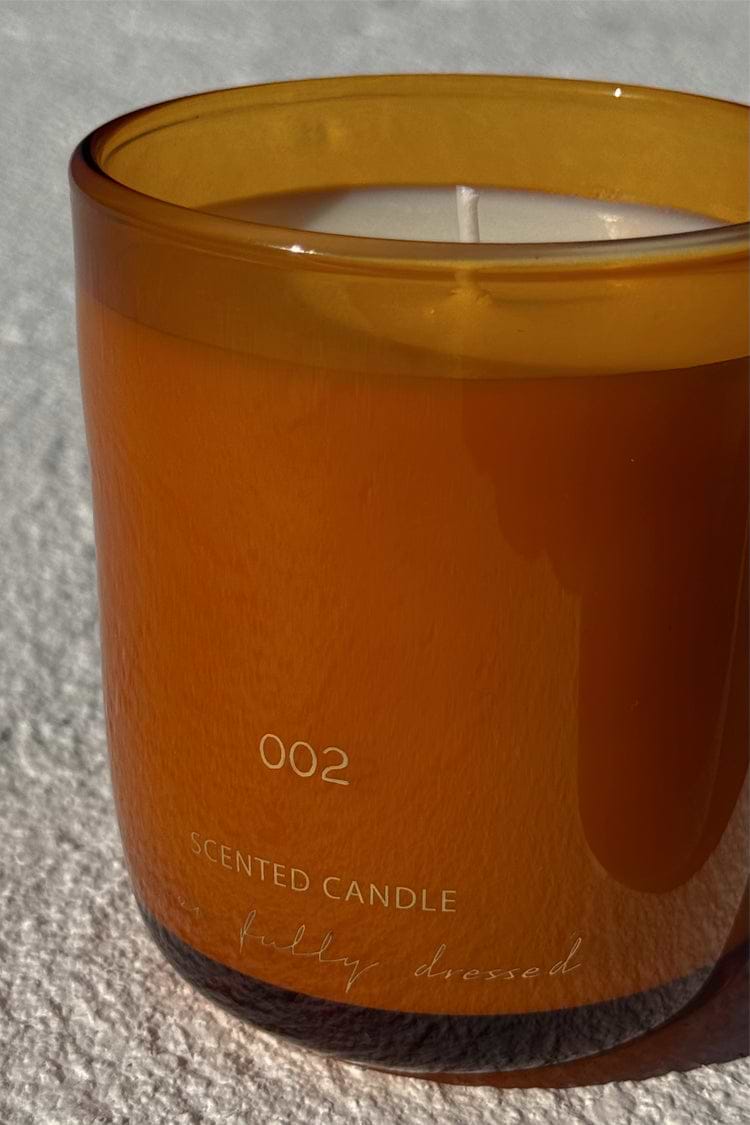 NFD Eau De Parfum Candle 002 in a mandarin-toned glass jar with signature branding.