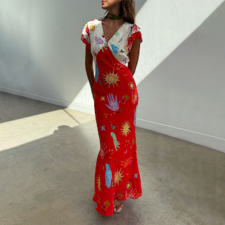 Red Celestial Midi Dress featuring a V-neckline and colourful sun and hand motifs on a cream and red viscose base.