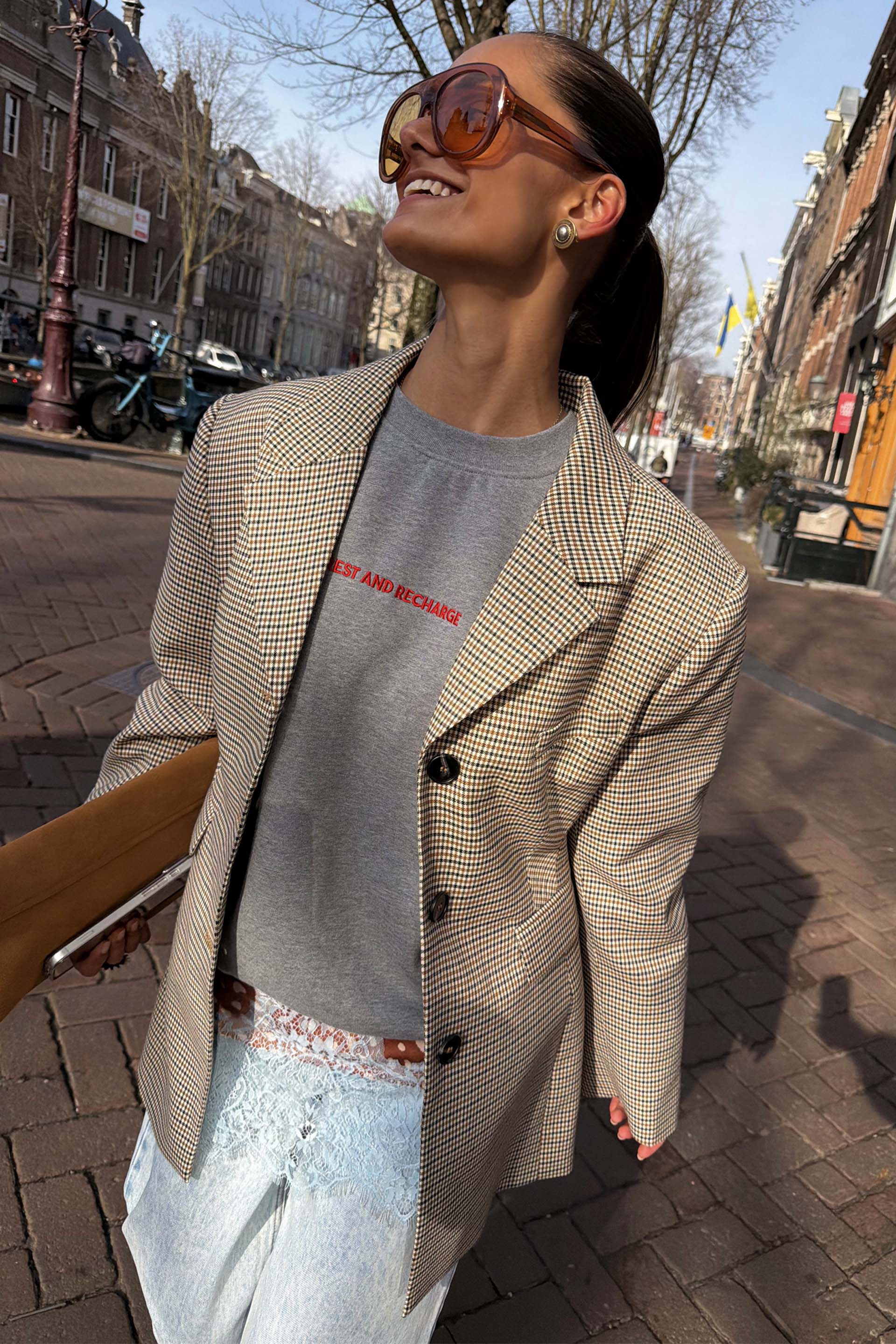 Tailored grey Check Blazer layered over a sweatshirt for a transeasonal street style London look.