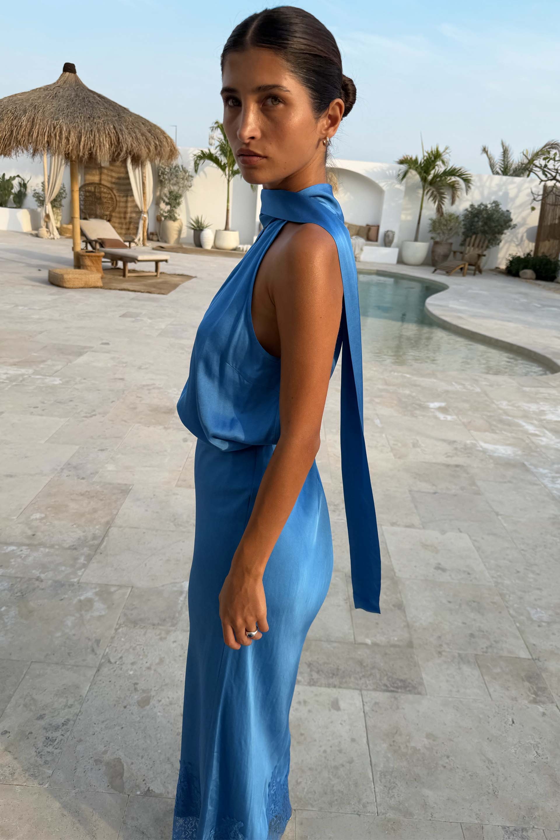 Cobalt Lily Top in blue satin-esque fabric with a multi-wear tie neck, styled as a vacation co-ord by a pool.
