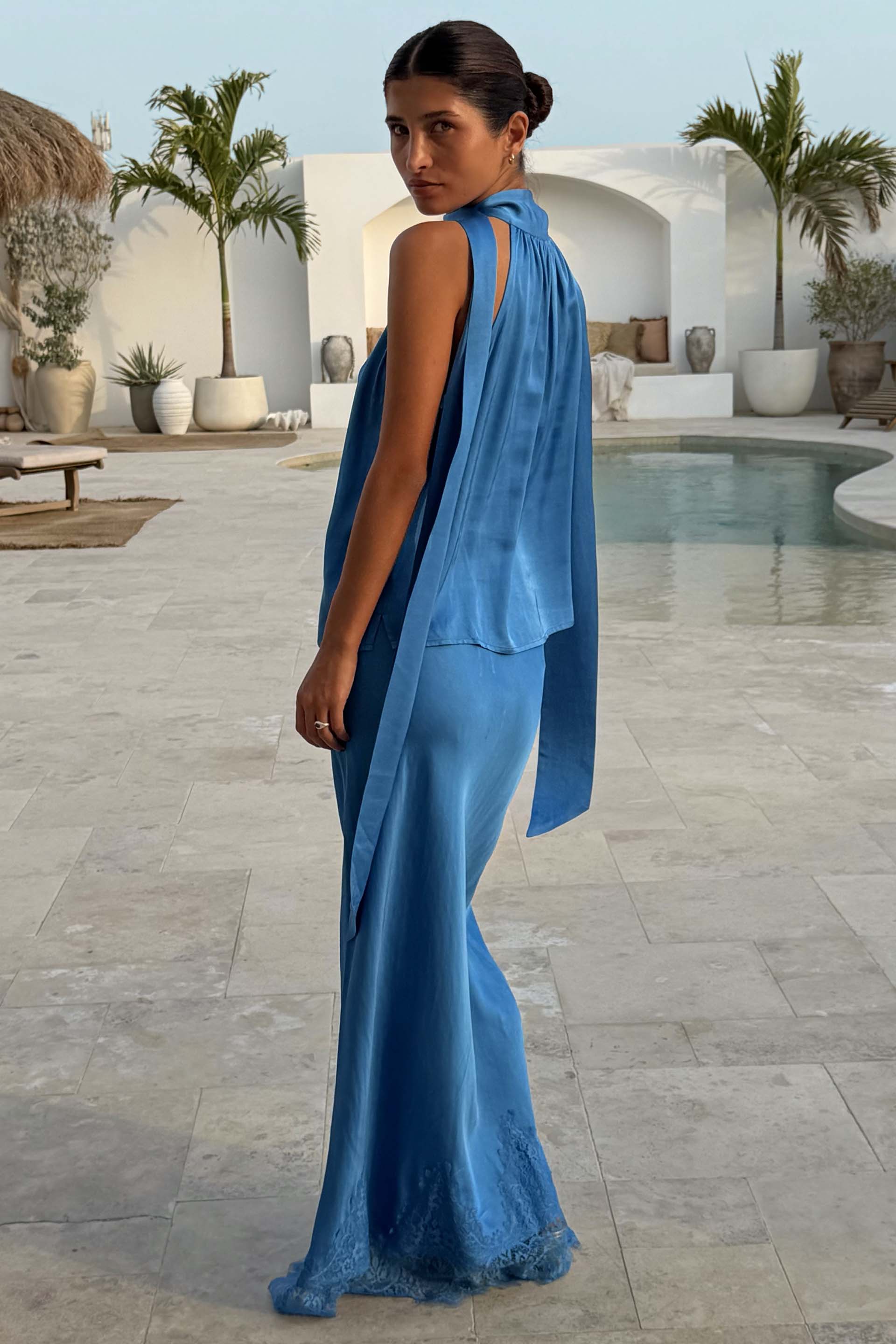 Cobalt Maeva Midi Skirt with a lace hem and matching top, styled as a co-ord in a poolside vacation setting.