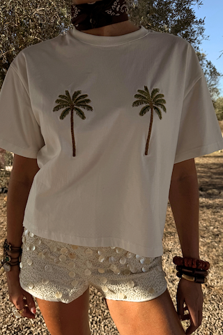 Cream Shells Hot Pants with shell and glass beading, styled with a palm tree tee for a vacation look.