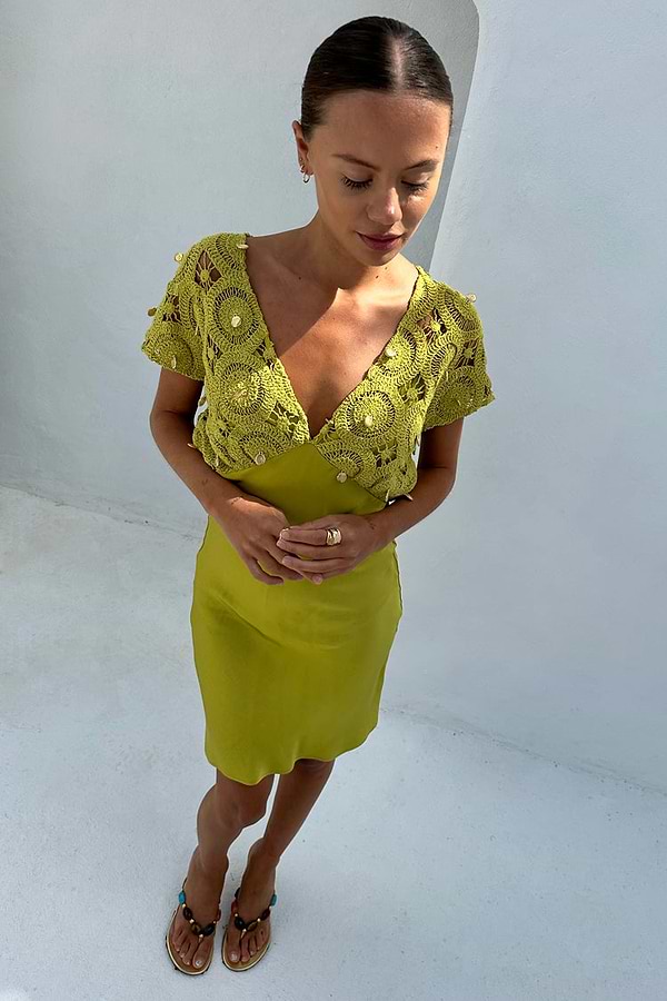 Green Shell Mini Elodie Dress in lime featuring a crochet knit bodice with gold charms and a satin mini skirt.