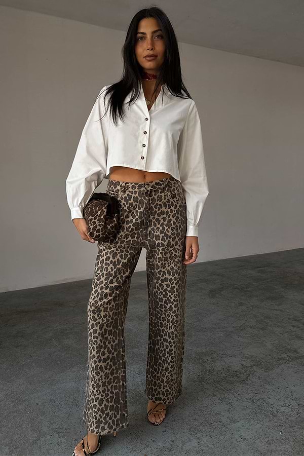 White Cropped Cotton Miley Shirt with tortoise buttons and blouson sleeves, styled with leopard print trousers.