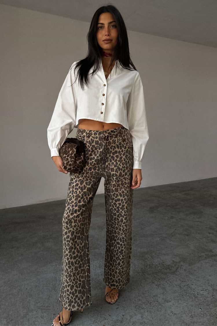White Cropped Cotton Miley Shirt with tortoise buttons and blouson sleeves, styled with leopard print trousers.