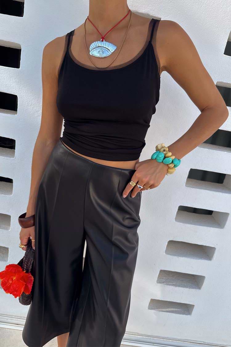 Black Vegan Leather Culottes featuring a wide leg and front crease, styled with turquoise accessories.