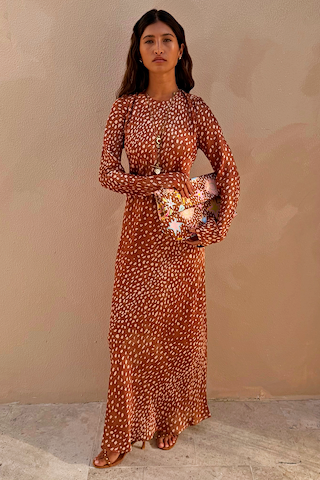 Fawn Soho Maxi Dress in brown satin-esque fabric with a cream deer print and flared sleeves on a model.