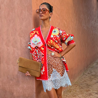 Tomato Tapestry Martha Cardigan with celestial motifs, styled with a lace-trimmed deer print skirt.