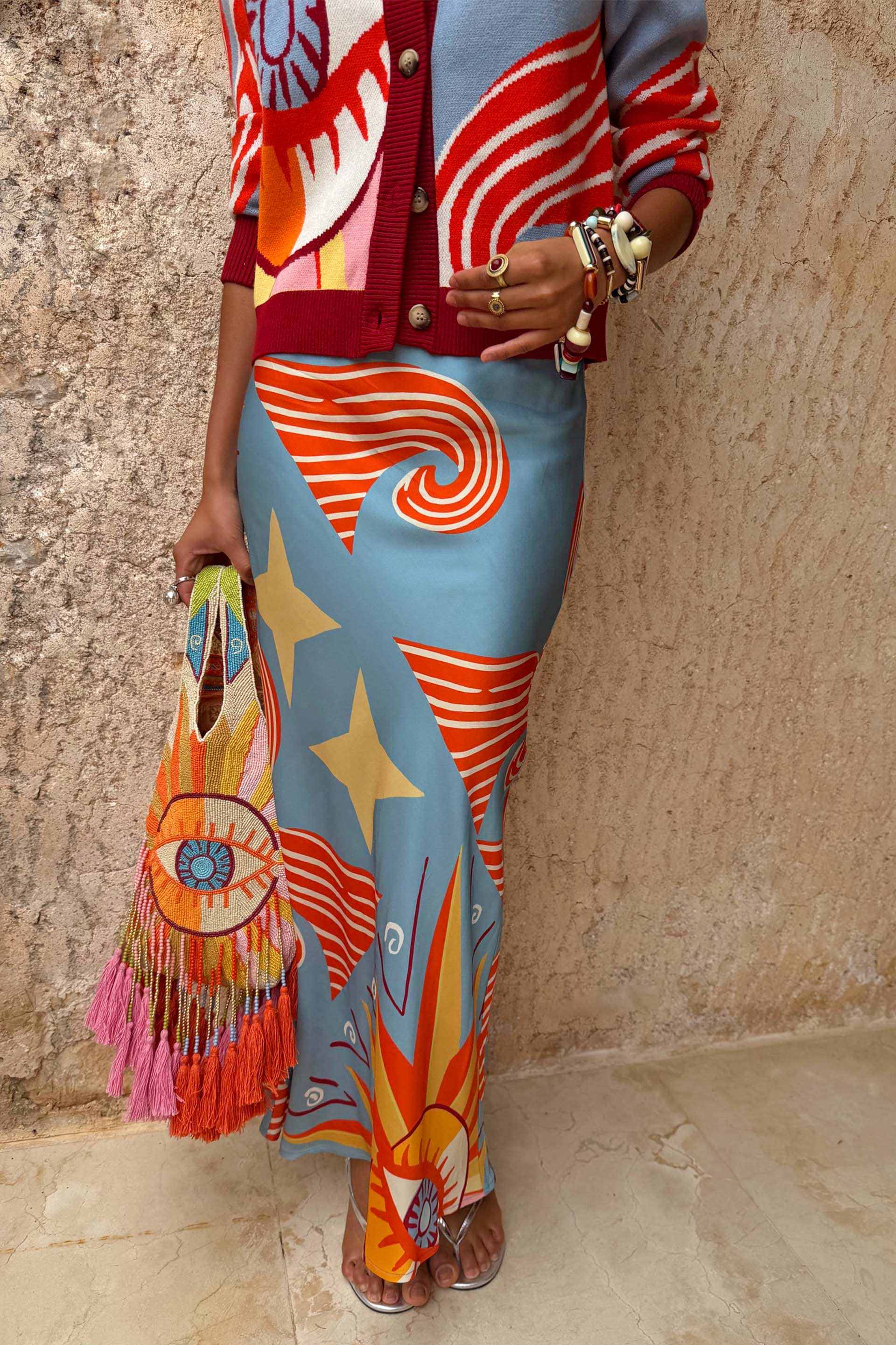 Blue Dolce Vita Dorris Skirt featuring sun and wave motifs in a satin-feel bias-cut silhouette.
