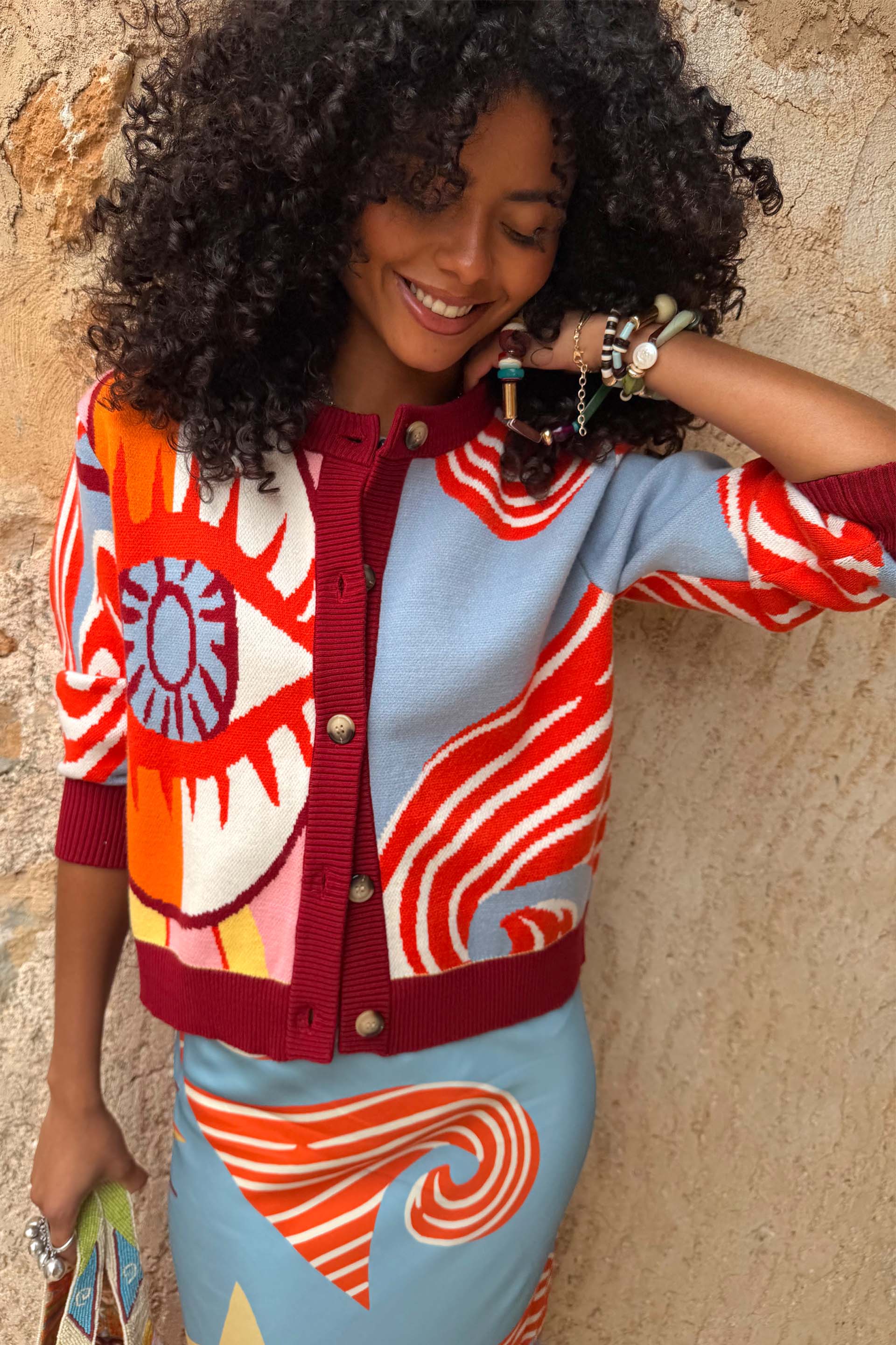 Dolce Vita Hollie Cardigan featuring an eye graphic, colour-block knit and burgundy ribbed trims.