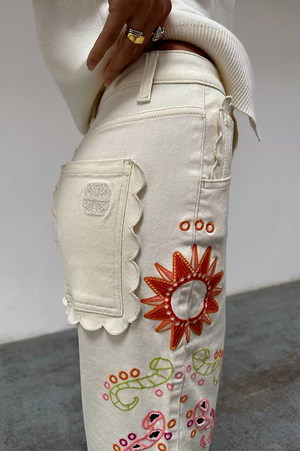 Ecru Enchanted Cut Work Scallop Jeans with a scalloped back pocket and colourful embroidered sun motif.