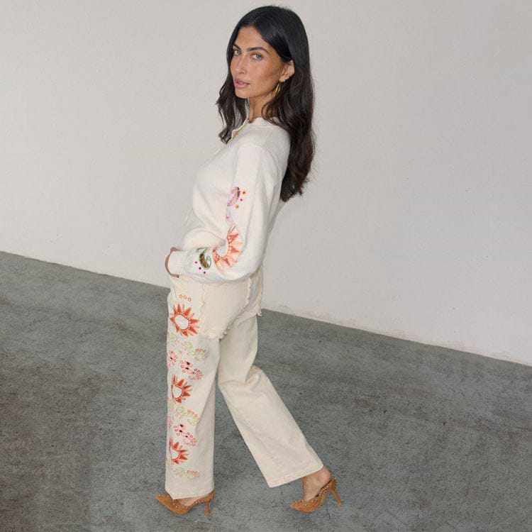 Ecru Enchanted Cut Work Scallop Jeans with sun embroidery and wide-leg fit, paired with a matching cardigan.