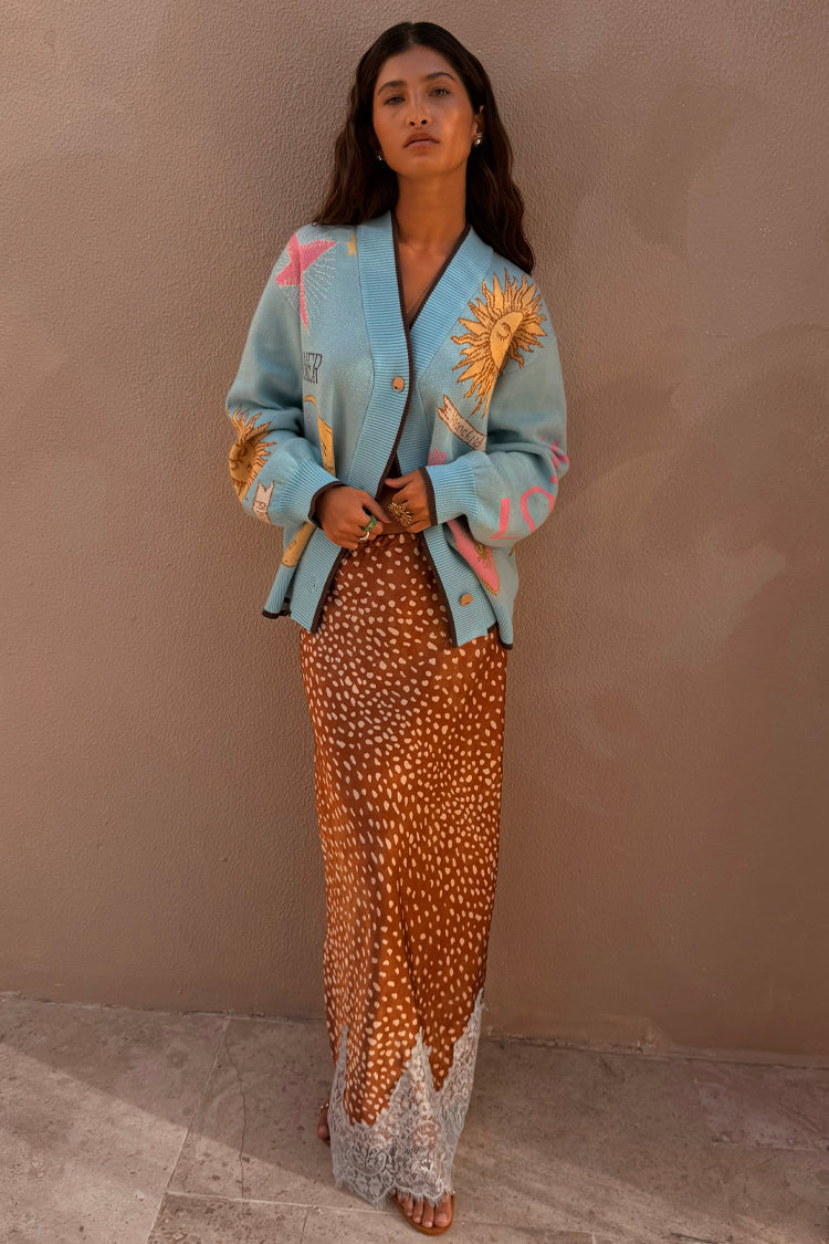 Fawn print Maeva midi skirt with a brown base and white lace trim, styled with a light blue graphic cardigan.