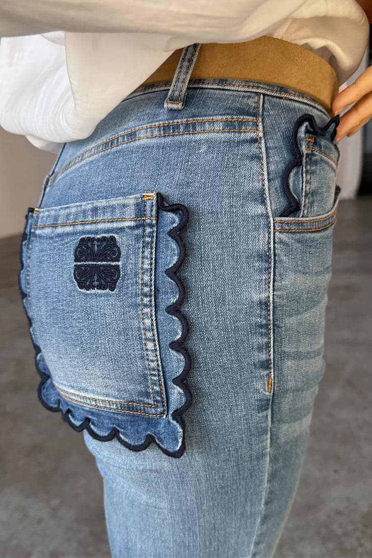 NFD Denim Flare Scallop Jean in blue with navy scalloped pockets and an embroidered logo on the back.