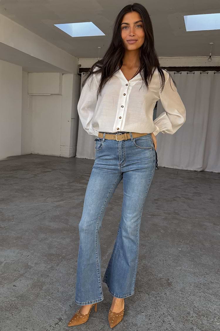 Blue Denim Flare Scallop Jean with a 70s flared silhouette, styled with a white button-down blouse.