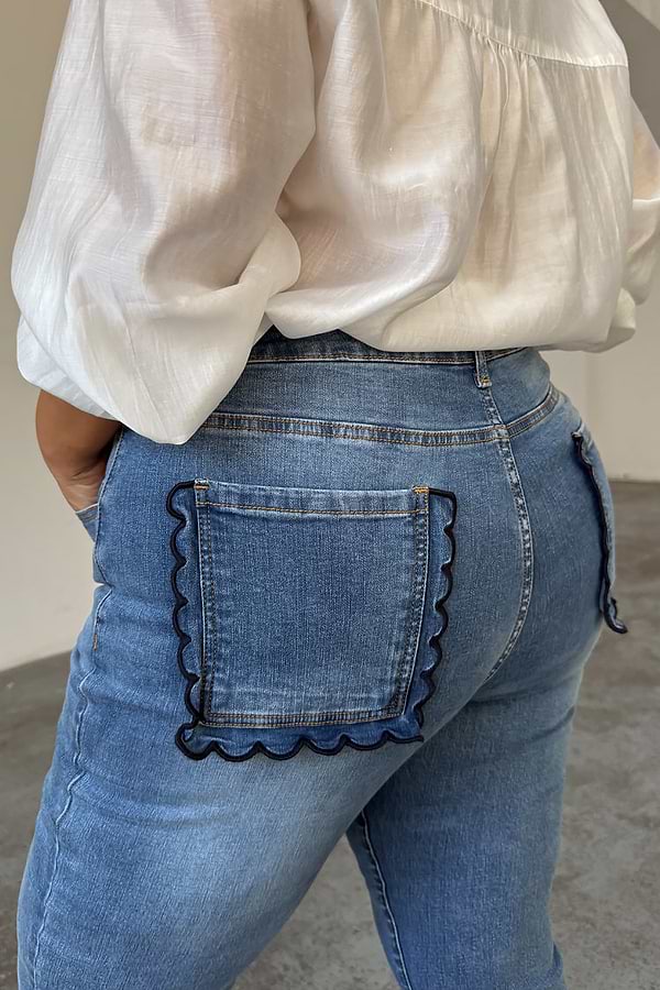 Blue Denim Flare Scallop Jean highlighting the navy scalloped pocket detail on a curve model.