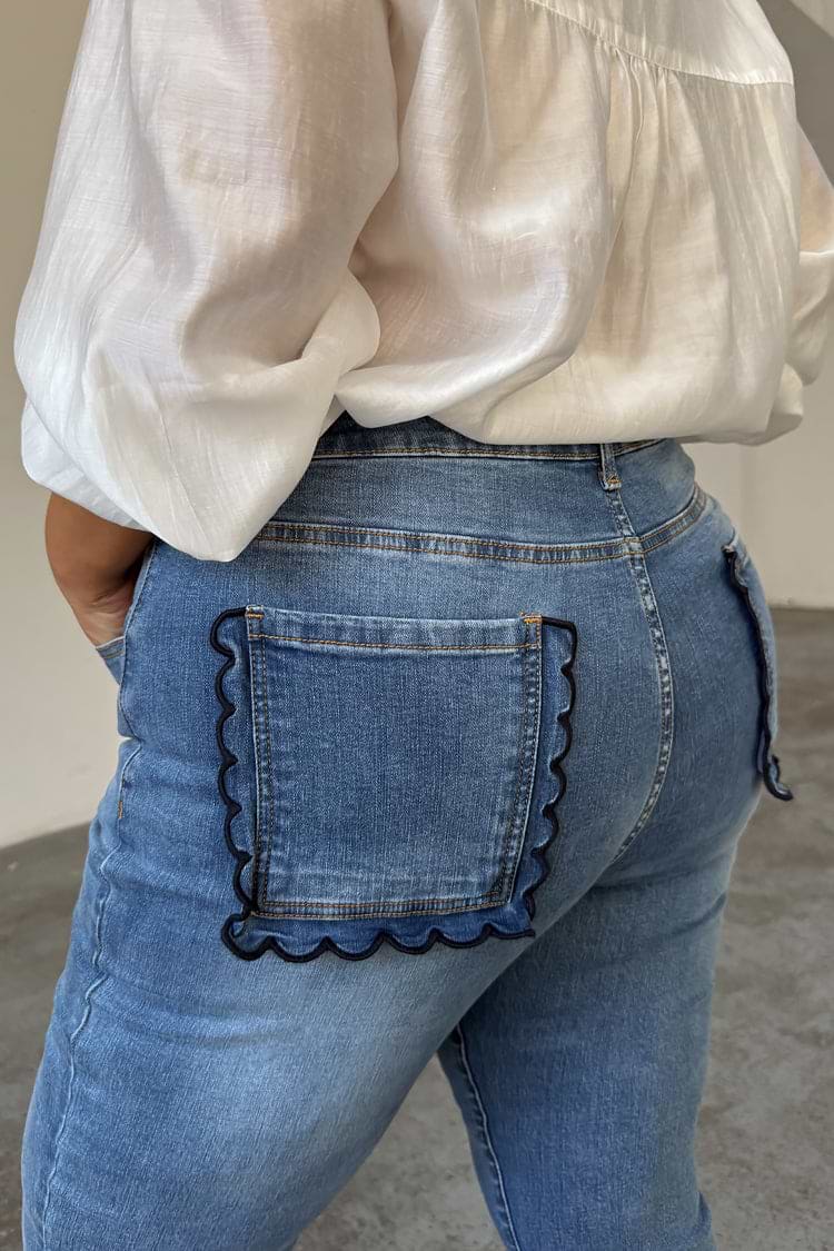 Blue Denim Flare Scallop Jean highlighting the navy scalloped pocket detail on a curve model.