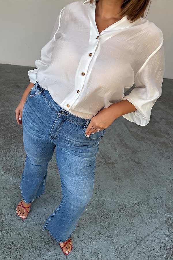 Blue Denim Flare Scallop Jean with 70s-style flared cuffs and scalloped pockets, shown on a size 18 model.