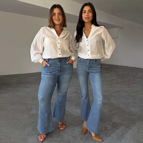 Blue Denim Flare Scallop Jean with a 70's silhouette, shown on two models for inclusive sizing.