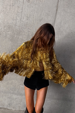 Metallic Gold Fringe Jacket featuring layered foil tassels and a cropped fit, styled for partywear.