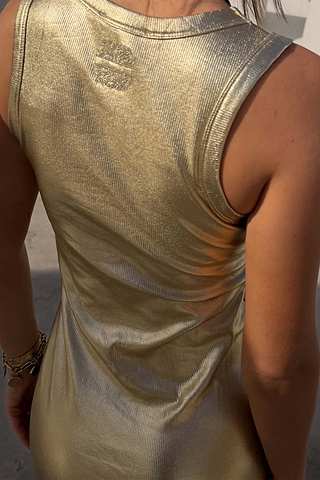 Gold Metallic Ribbed Dress detail featuring shimmering gold textured fabric and a sleeveless back design.