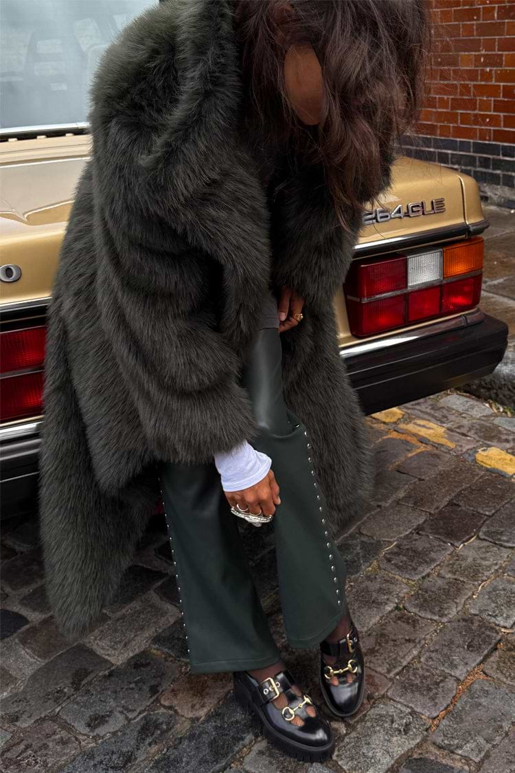 Green Faux Fur Coat in a relaxed silhouette, styled as a statement staple for a London street look.