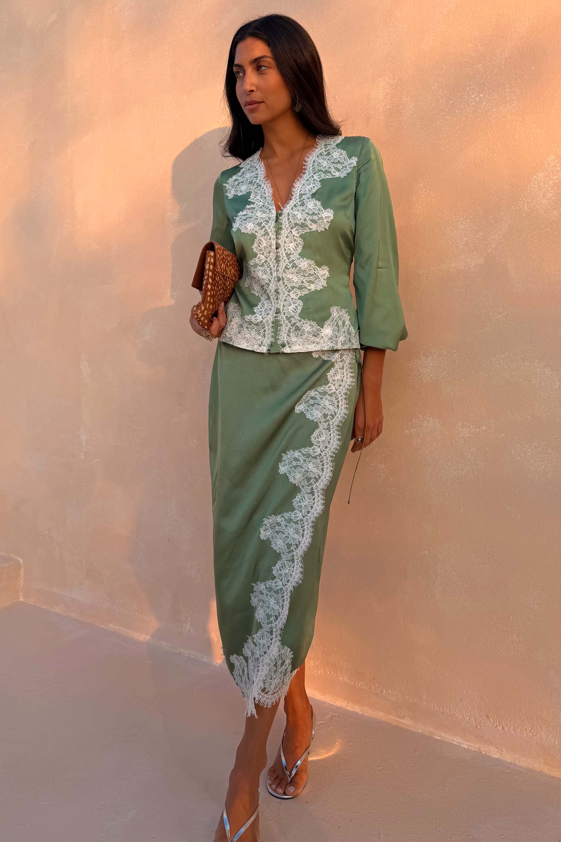 Green Lace Wrap Midi Skirt with cascading white lace and tie waist, styled with a matching top on a model.
