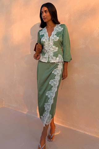 Green Lace Wrap Midi Skirt with cascading white lace and tie waist, styled with a matching top on a model.