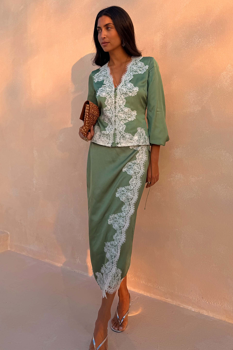 Green Lace Wrap Midi Skirt with cascading white lace and tie waist, styled with a matching top on a model.