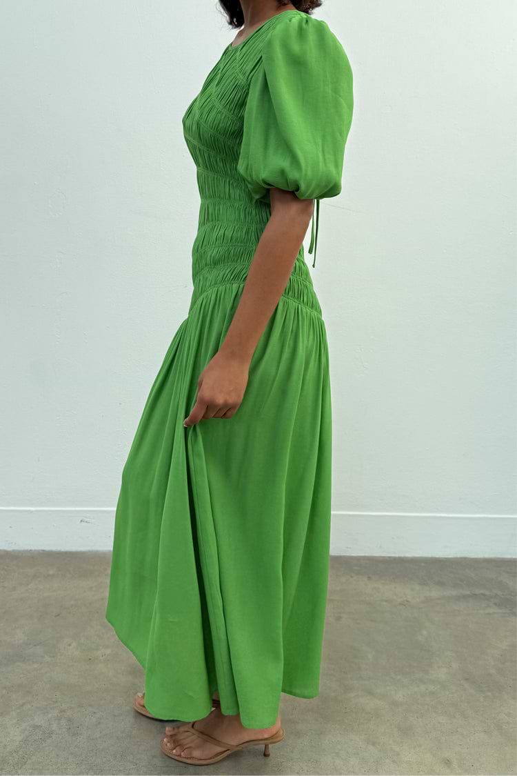 Green Shirred Nara Dress featuring a shirred bodice, puff sleeves and a pleated midaxi skirt.