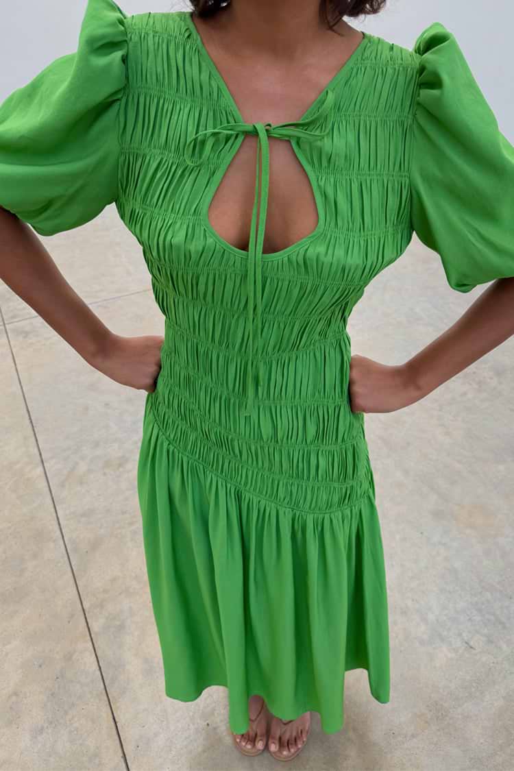 Green Shirred Nara Dress featuring a multi-wear tie neck, puff sleeves, and an elasticated smocked bodice.