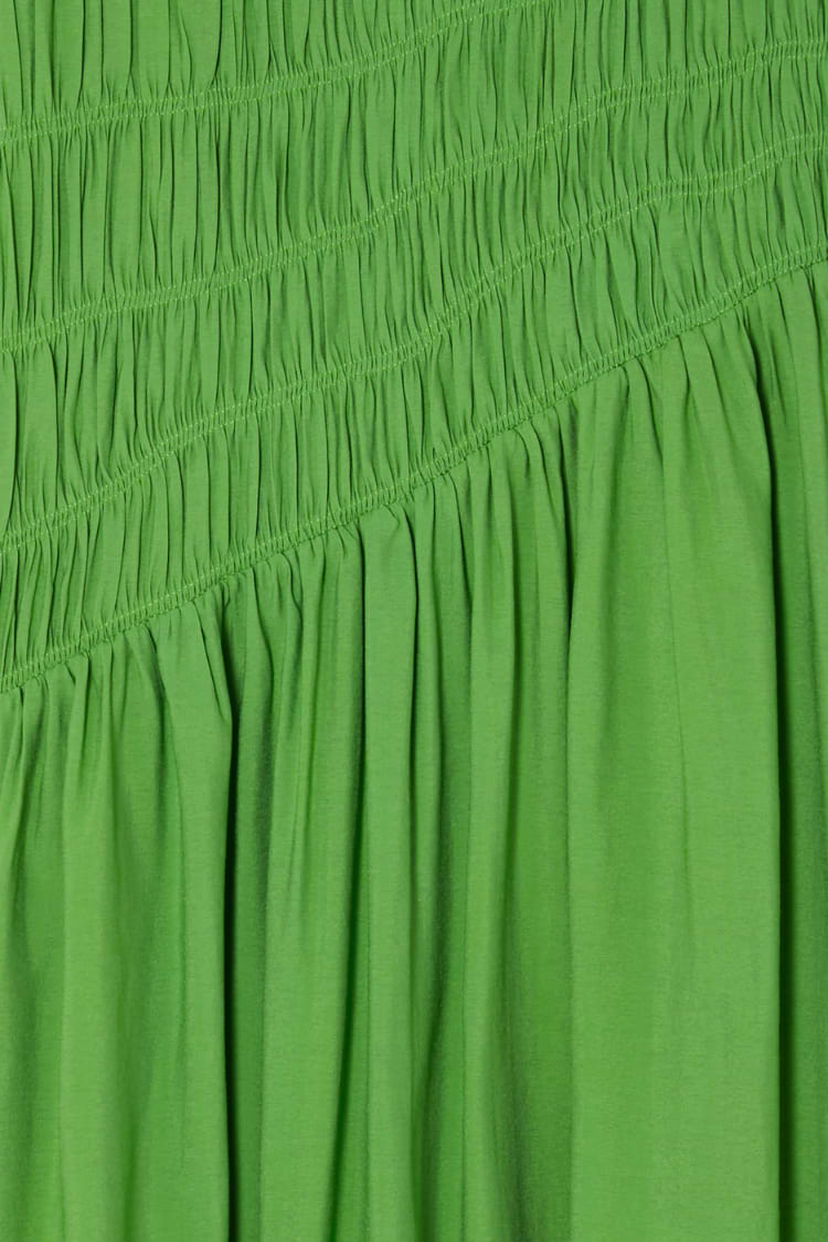 Green Shirred Nara Dress close-up highlighting the elastic shirring and lightweight pleated green fabric.