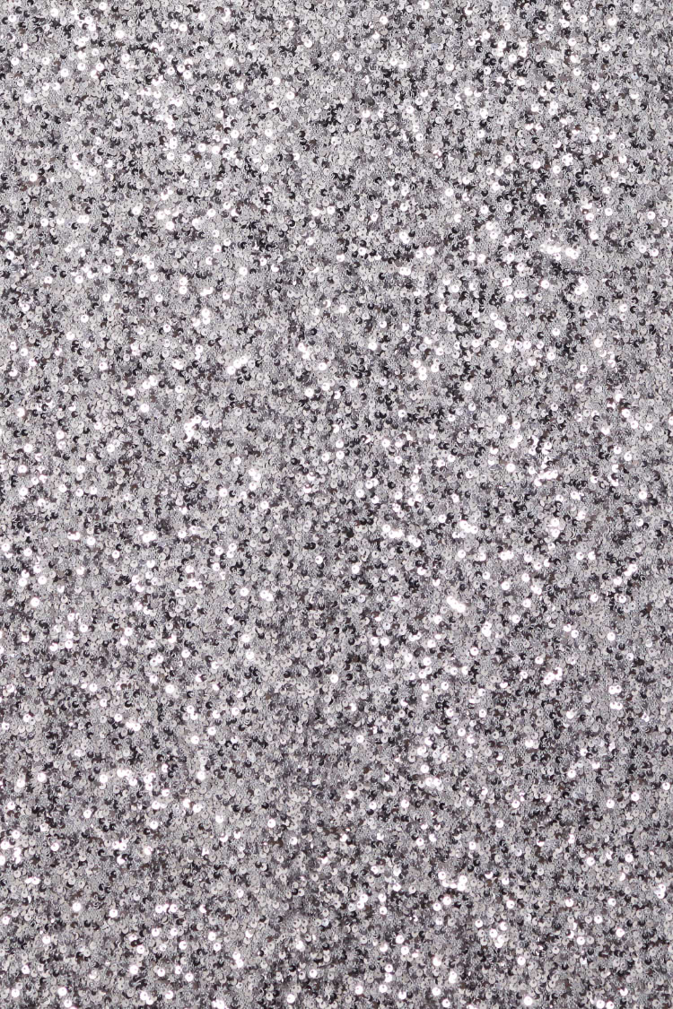 Shimmering gunmetal grey sequins on the Soho Dress, highlighting the dense metallic sparkle of the fabric.