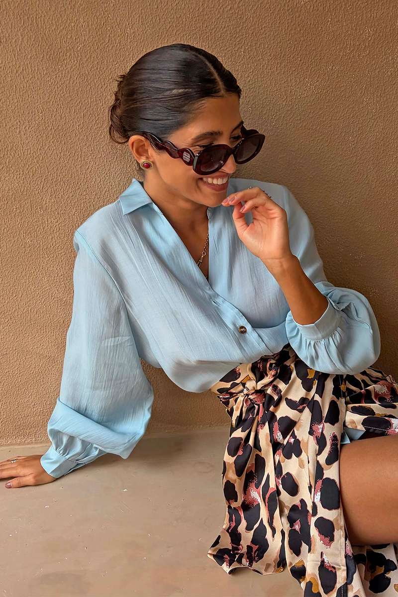Never Fully Dressed Ice Blue Miley Shirt with blouson sleeves, paired with a leopard print wrap skirt.