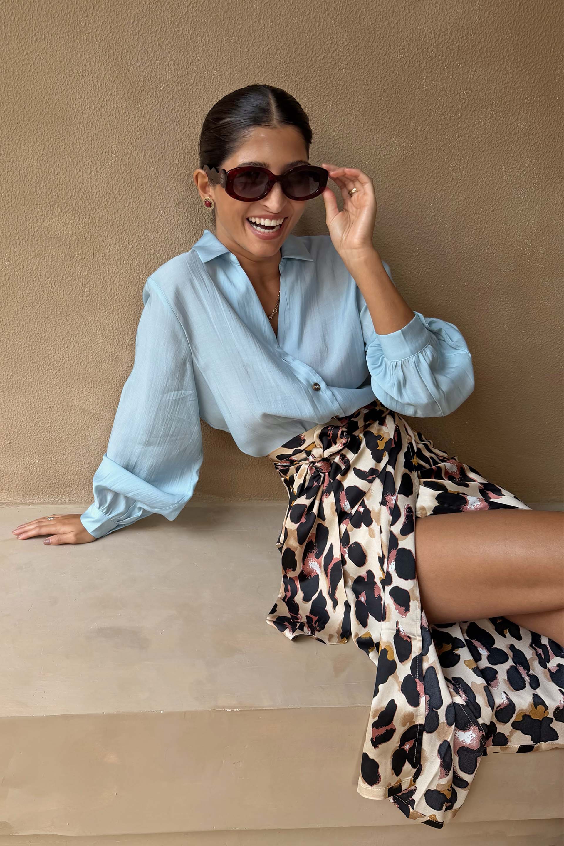 Ice Blue Miley Shirt with blouson sleeves styled with a leopard print wrap skirt.