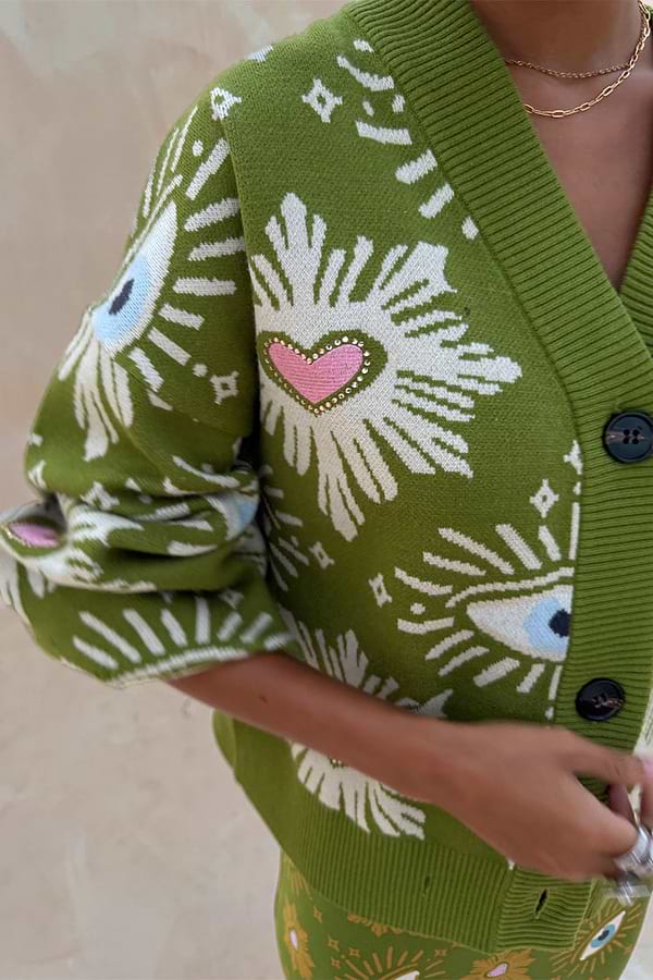 Khaki Eye Cardigan featuring iconic NFD eye and heart motifs on green knitwear with button-up detail.