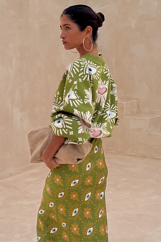 Khaki Eye Cardigan featuring embroidered eye and heart motifs, styled with a matching knitted skirt.