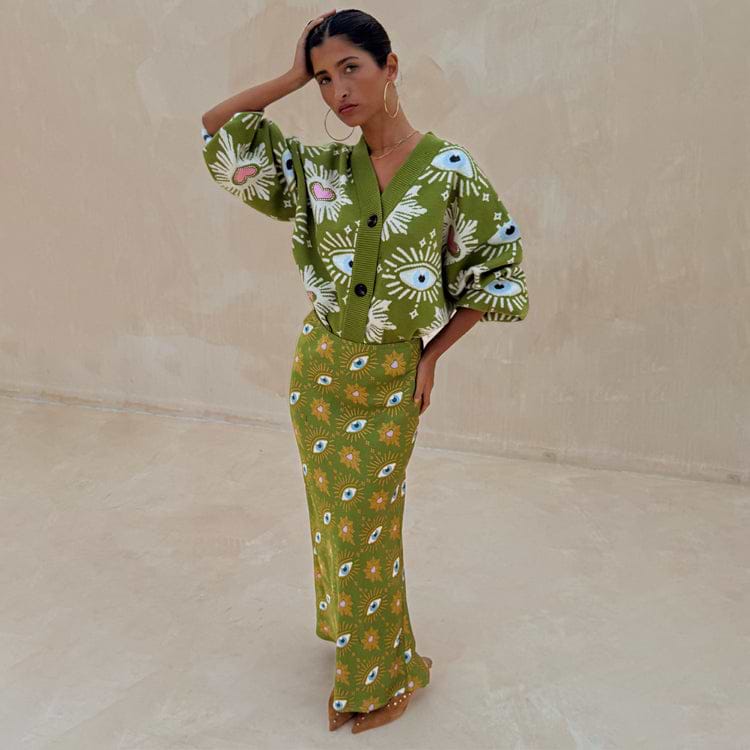 Khaki Eye Dorris Skirt featuring mystical eye and heart prints, styled with a matching green cardigan.