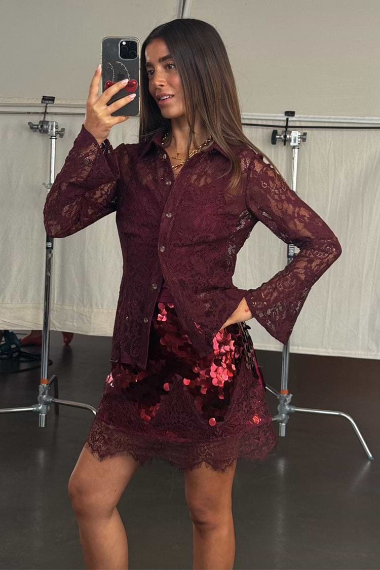 Burgundy lace shirt with flared cuffs and matching sequin mini skirt, shown in a mirror selfie.