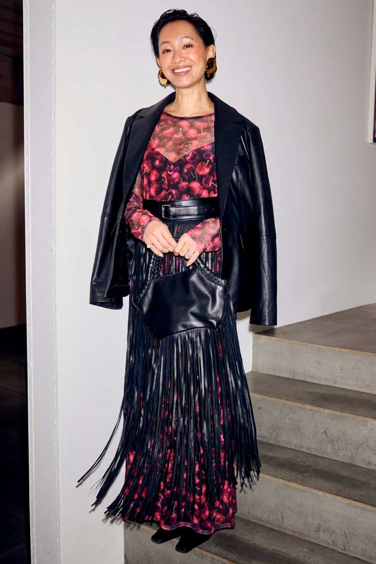Black Leather Blazer draped over a cherry-print dress and fringed bag for a multi-wear transeasonal look.